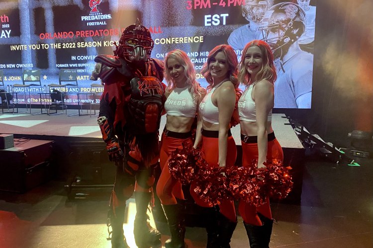 Mascot "Claw" poses with the Preds' cheer and dance team