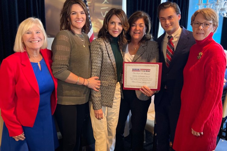 Genean McKinnon, family and friends accept the Roger S. Swanson Lifetime Achievement Award for McKinnon's father Gene Hawkins, and late mother Sen. Paula Hawkins.